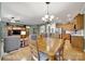 Open-concept dining area with wood table and seamless flow into kitchen and living space at 2213 Hartwell Ln # 84, Indian Land, SC 29707