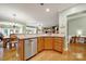 Bright kitchen featuring modern stainless steel appliances, wood cabinets, and seamless flow into dining and living areas at 2213 Hartwell Ln # 84, Indian Land, SC 29707