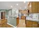 Open kitchen with stainless steel refrigerator, wooden cabinets, stylish counters and an easy flow layout at 2213 Hartwell Ln # 84, Indian Land, SC 29707