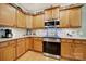 Well-equipped kitchen with stainless steel oven, cooktop, ample wooden cabinetry, and stylish tile backsplash at 2213 Hartwell Ln # 84, Indian Land, SC 29707