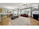 Open-concept living room and dining area with hardwood floors and abundant natural light at 2213 Hartwell Ln # 84, Indian Land, SC 29707