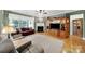 Spacious living room featuring a fireplace, TV, hardwood floors, and large windows at 2213 Hartwell Ln # 84, Indian Land, SC 29707