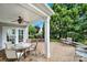 Covered patio showcasing a ceiling fan, a dining table, outdoor furniture, and beautiful landscaping at 2213 Hartwell Ln # 84, Indian Land, SC 29707