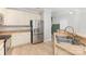 Kitchen featuring stainless steel refrigerator and sink, neutral countertops, and wooden cabinets at 230 Dawn Mist Ln, Fort Mill, SC 29708
