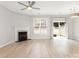 Open-concept living space showcasing modern lighting, neutral walls and beautiful light wood-look floors at 230 Dawn Mist Ln, Fort Mill, SC 29708