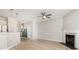 Open-concept living space with wood-look floors, a fireplace, and modern lighting fixtures at 230 Dawn Mist Ln, Fort Mill, SC 29708