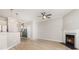 Open-concept living space with wood-look floors, a fireplace, and modern lighting fixtures at 230 Dawn Mist Ln, Fort Mill, SC 29708