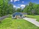 Captivating aerial view of a charming single-story home with a carport, surrounded by lush landscaping and greenery at 2302 Douglas Rd, Lancaster, SC 29720