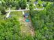 Aerial view of a home with lush green tree surround featuring a pool and a storage shed at 2302 Douglas Rd, Lancaster, SC 29720