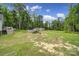 Backyard featuring an above ground pool, storage shed and a spacious green yard at 2302 Douglas Rd, Lancaster, SC 29720