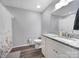 Bathroom featuring a white vanity, large mirror and shower with a floral shower curtain at 2302 Douglas Rd, Lancaster, SC 29720