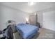 Simple bedroom with bed, gray furniture, and carpet at 2302 Douglas Rd, Lancaster, SC 29720