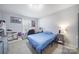 Clean bedroom featuring carpet, blue bed, and gray decor at 2302 Douglas Rd, Lancaster, SC 29720