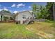 Back exterior of home featuring a back deck with a patio and a lush green yard at 2302 Douglas Rd, Lancaster, SC 29720
