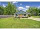 Charming single-story home with a welcoming front porch, rocking chairs, carport, and a well-manicured lawn at 2302 Douglas Rd, Lancaster, SC 29720