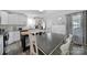 Well-lit kitchen with white cabinets, dark countertops, and a spacious dining area at 2302 Douglas Rd, Lancaster, SC 29720