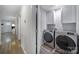 Hallway view of the laundry room featuring washer and dryer and white storage cabinets at 2302 Douglas Rd, Lancaster, SC 29720