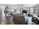 Open-concept living room featuring wood floors and neutral tones, seamlessly connecting to a modern kitchen and dining area at 2302 Douglas Rd, Lancaster, SC 29720