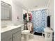Light, bright bathroom with a shark-themed shower curtain and updated fixtures at 238 N Depot St, Albemarle, NC 28001