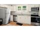 Modern kitchen featuring stainless steel appliances, white cabinets, and granite countertops at 238 N Depot St, Albemarle, NC 28001