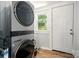 Laundry room featuring a stacked washer and dryer and hardwood floors at 238 N Depot St, Albemarle, NC 28001