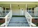 Close up of the front porch with a white railing and stairs leading to the entrance door at 238 N Depot St, Albemarle, NC 28001