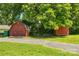 View of two storage sheds in the backyard with a driveway leading up to them at 238 N Depot St, Albemarle, NC 28001