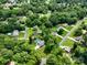 Beautiful aerial perspective featuring neighborhood homes nestled amidst a canopy of mature trees and green spaces at 240 Hillcrest Dr, Harrisburg, NC 28075