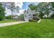Beautiful landscaped lawn and driveway of single Gathering home at 240 Hillcrest Dr, Harrisburg, NC 28075