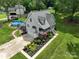 Aerial shot of a charming home featuring an attached garage, landscaped garden, and above-ground pool at 240 Hillcrest Dr, Harrisburg, NC 28075