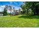 A well-maintained home set on a large, lush green lawn with mature trees and landscaping at 240 Hillcrest Dr, Harrisburg, NC 28075