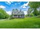 Inviting home with an American flag, a covered front porch, and a meticulously landscaped front yard at 240 Hillcrest Dr, Harrisburg, NC 28075