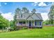 Charming single Gathering home featuring a covered porch, landscaped yard, and welcoming curb appeal at 240 Hillcrest Dr, Harrisburg, NC 28075