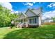 Inviting home featuring a covered front porch and a well-manicured lawn at 240 Hillcrest Dr, Harrisburg, NC 28075