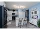 Bright kitchen with white cabinets, an island with seating, and modern appliances at 240 Hillcrest Dr, Harrisburg, NC 28075