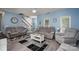 Spacious living room with comfortable seating and an open view of the staircase at 240 Hillcrest Dr, Harrisburg, NC 28075
