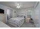 Serene main bedroom featuring a large bed, ceiling fan, and natural light at 240 Hillcrest Dr, Harrisburg, NC 28075