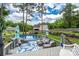 Inviting pool deck with comfortable seating, shade umbrellas, and a view of the fenced backyard at 240 Hillcrest Dr, Harrisburg, NC 28075