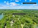 Aerial view of homes in a wooded community, close to retail at The Village @ Byers Creek, Mooresville, NC at 266 Riverwood Rd, Mooresville, NC 28117