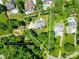 Aerial view of a property showcasing its spacious lot size surrounded by lush greenery and mature trees at 266 Riverwood Rd, Mooresville, NC 28117