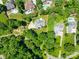Aerial view of a property showcasing its spacious lot size surrounded by lush greenery and mature trees at 266 Riverwood Rd, Mooresville, NC 28117
