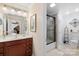 Well-lit bathroom with a glass-enclosed shower, functional vanity, and neutral-toned decor at 266 Riverwood Rd, Mooresville, NC 28117