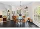 Bright breakfast nook featuring many windows, modern chandelier, and four chairs at 266 Riverwood Rd, Mooresville, NC 28117