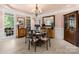 Elegant dining room with refined furniture, wainscoting, large window, and chandelier at 266 Riverwood Rd, Mooresville, NC 28117