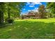 Beautiful brick home with a well-manicured lawn and vibrant landscaping creating an inviting and picturesque curb appeal at 266 Riverwood Rd, Mooresville, NC 28117