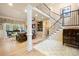 Grand foyer showcasing a staircase with iron railings, decorative tile flooring, and natural light at 266 Riverwood Rd, Mooresville, NC 28117