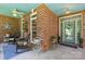 Inviting front porch with a charming brick wall, cozy rocking chairs, and decorative plants at 266 Riverwood Rd, Mooresville, NC 28117