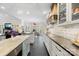 Bright, open kitchen with custom range hood, white cabinetry, and a view to dining area at 266 Riverwood Rd, Mooresville, NC 28117