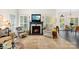 Cozy living room featuring a fireplace, large windows, and comfortable seating arrangements perfect for relaxation at 266 Riverwood Rd, Mooresville, NC 28117