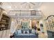 Inviting living room featuring a soaring ceiling, elegant staircase, and comfortable seating arrangement at 266 Riverwood Rd, Mooresville, NC 28117